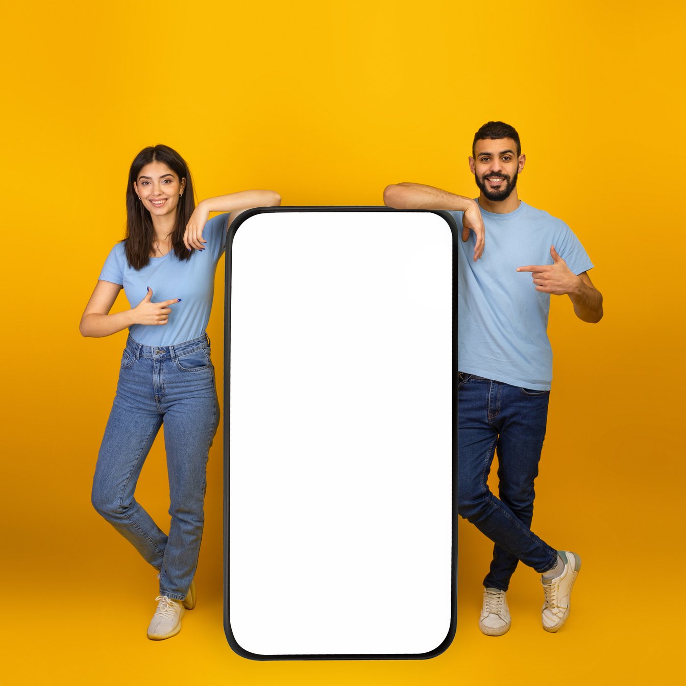 Great Mobile App. Young Arab Couple Pointing at Big Smartphone with Empty Screen Mockup, Promoting App or Website